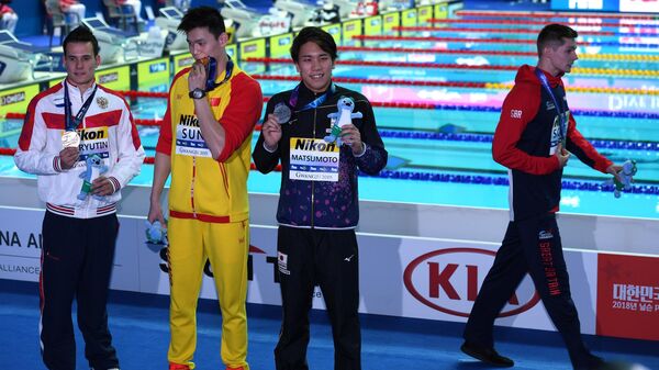 Британский пловец Данкан Скотт покидает церемонию награждения ЧМ по водным видам спорта в Кванджу в знак протеста против китайца Сунь Яна, замешанного в допинг-скандале.