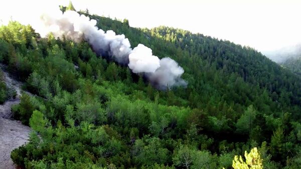 Контролируемый взрыв, произведенный сотрудниками противопожарной службы ФБУ Авиалесоохрана для предотвращения распространения лесных пожаров в Красноярском крае