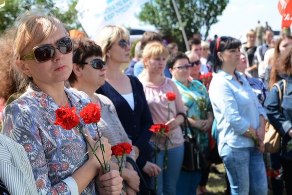 Участники траурной церемонии на месте гибели фотокорреспондента Международного информационного агентства Россия сегодня Андрея Стенина