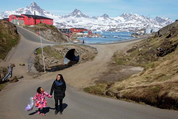 Женщина с ребенком на улице в Тасиилаке, Гренландия