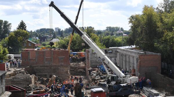 Сотрудники МЧС разбирают перекрытия, рухнувшие в строящемся здании в Новосибирске