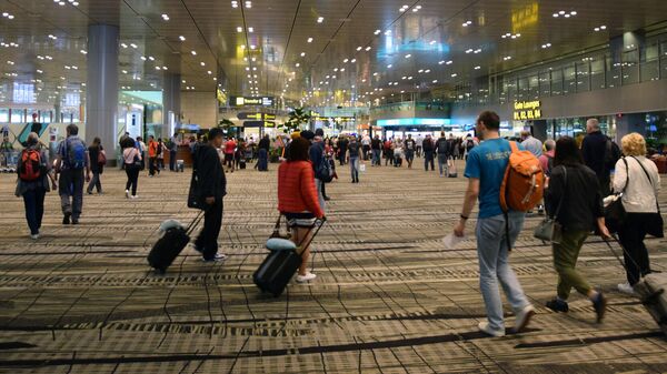 Пассажиры в аэропорту Чанги в Сингапуре