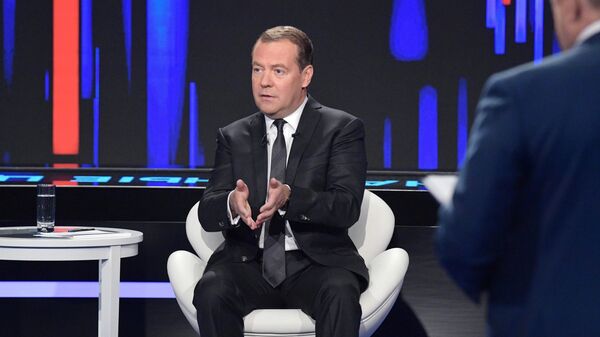 Председатель правительства РФ Дмитрий Медведев во время программы Диалог на канале Россия 24