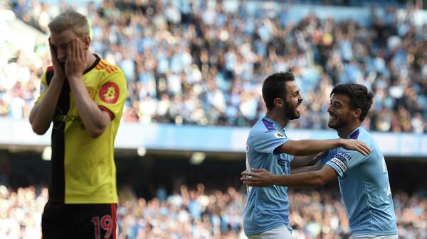 Manchester City's Portuguese midfielder Bernardo Silva (C) celebrates with Manchester City's Spanish midfielder David Silva (R) after he scores the team's seventh goal during the English Premier League football match between Manchester City and Watford at the Etihad Stadium in Manchester, north west England, on September 21, 2019. (Photo by Oli SCARFF / AFP) / RESTRICTED TO EDITORIAL USE. No use with unauthorized audio, video, data, fixture lists, club/league logos or 'live' services. Online in-match use limited to 120 images. An additional 40 images may be used in extra time. No video emulation. Social media in-match use limited to 120 images. An additional 40 images may be used in extra time. No use in betting publications, games or single club/league/player publications. / 