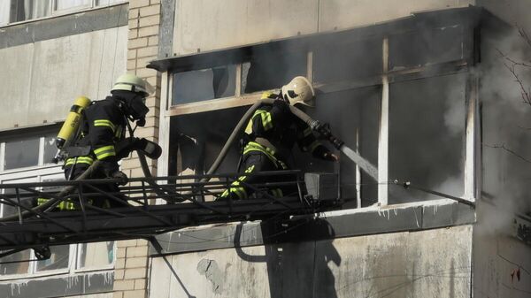 Сотрудники МЧС во время ликвидации пожара на лоджии жилого дома