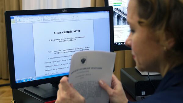 Сотрудник аппарата правительства подготавливает документы и материалы проекта бюджета на 2020-2022 годы