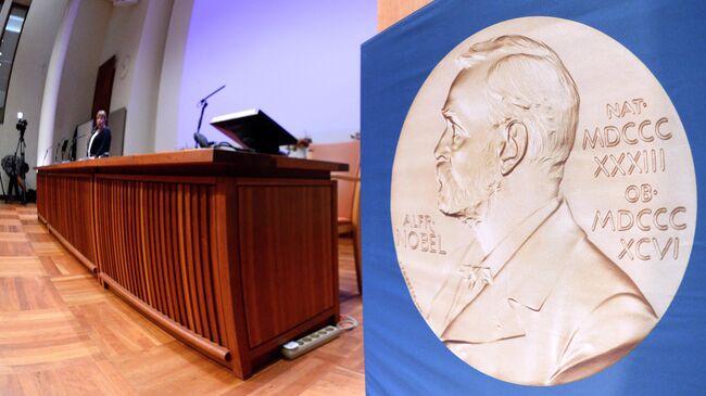 Изображение медали с портретом Альфреда Нобеля перед пресс-конференцией Нобелевского комитета