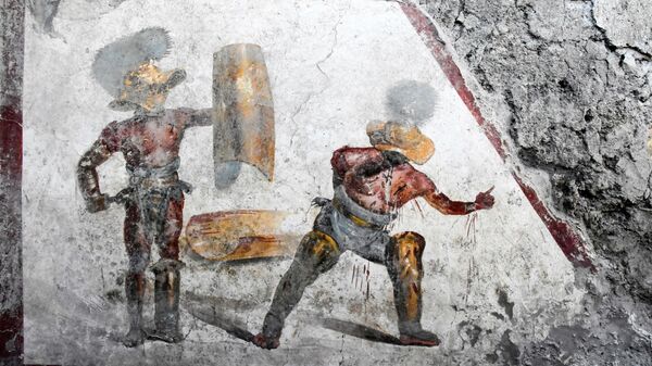Фреска с изображением гладиаторов, обнаруженная при раскопках в Помпеях, Италия