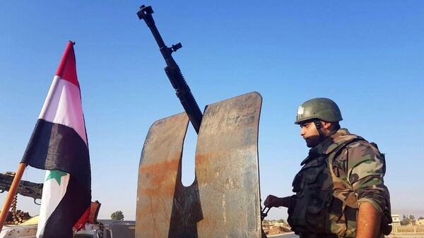 Сирийские военные в населенном пункте Телль-Тамер в 30 километрах от границы с Турцией
