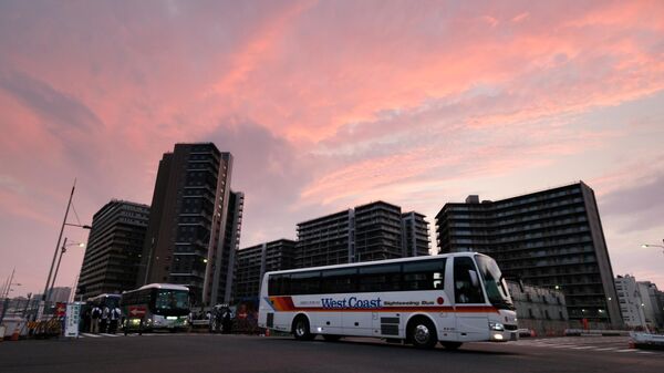 Buses depart the Olympic Village (background) durig a test of transportation measures planned for implementation during the Tokyo 2020 Opening Ceremony, in Tokyo on August 25, 2019. (Photo by Kazuhiro NOGI / AFP)