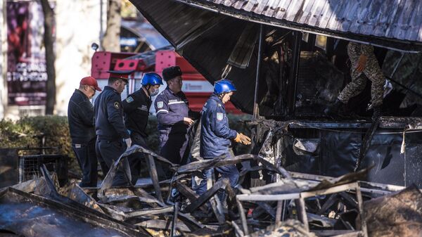 Сотрудники МЧС возле кафе Антошка на пересечении улиц Чуй и Эркиндик в Бишкеке, где произошли три взрыва и пожар