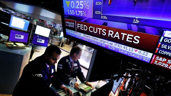 Экран на Нью-Йоркской фондовой бирже с новостью о снижении базовой процентной ставки, 30 октября 2019 года