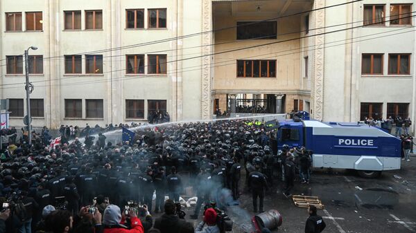 Сотрудники грузинского спецназа разгоняют акцию оппозиционеров у здания парламента Грузии