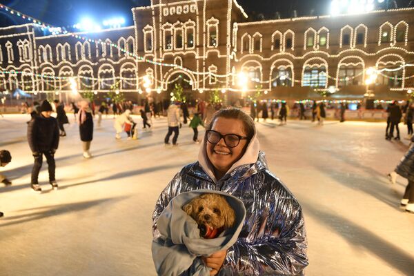 Посетительница вместе с собакой на открытии ГУМ-катка на Красной площади
