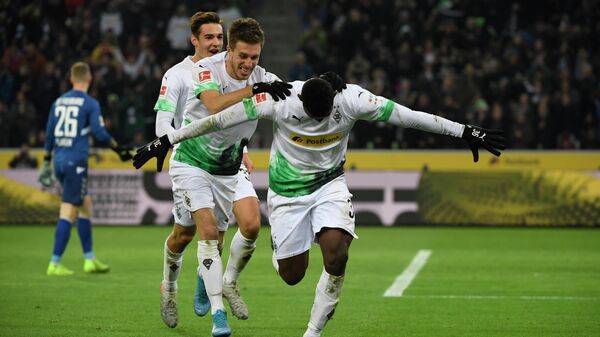 Moenchengladbach's Swiss forward Breel Embolo (R) celebrates with German forward Patrick Herrmann after scoring a goal during the German first division Bundesliga football match Borussia Moenchengladbach vs SC Freiburg in Moenchengladbach, western Germany on December 1, 2019. - Moenchengladbach's Swiss forward Breel Embolo (R) celebrates with German forward Patrick Herrmann after scoring a goal during the German first division Bundesliga football match Borussia Moenchengladbach vs SC Freiburg in Moenchengladbach, western Germany on December 1, 2019. (Photo by INA FASSBENDER / AFP)