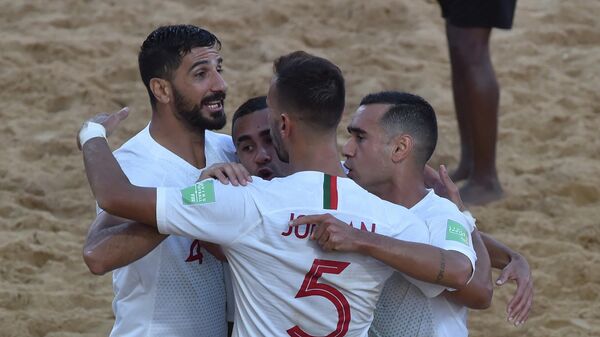 Portugal's players celebrates after scoring against Italy during their final FIFA Beach Soccer World Cup Paraguay 2019 football match at Los Pynandi stadium in Luque, Paraguay on December 1, 2019. (Photo by NORBERTO DUARTE / AFP)
