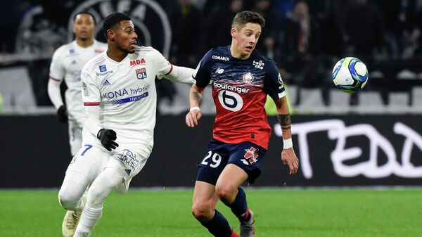 Lyon's French midfielder Jeff Reine-Adelaide (L) fights for the ball with Lille's Croatian defender Domagoj Bradaric (R) during the French L1 football match between Lyon (OL) and Lille (LOSC) at the Groupama stadium in Decines-Charpieu near Lyon, southeastern France, on December 3, 2019. (Photo by JEAN-PHILIPPE KSIAZEK / AFP)