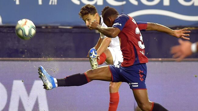 Sevilla's Spanish midfielder Jesus Navas (L) vies with Osasuna's Ecuadorian defender Pervis Estupinan during the Spanish league football match between CA Osasuna and Sevilla FC at El Sadar stadium in Pamplona on December 8, 2019. (Photo by ANDER GILLENEA / AFP)