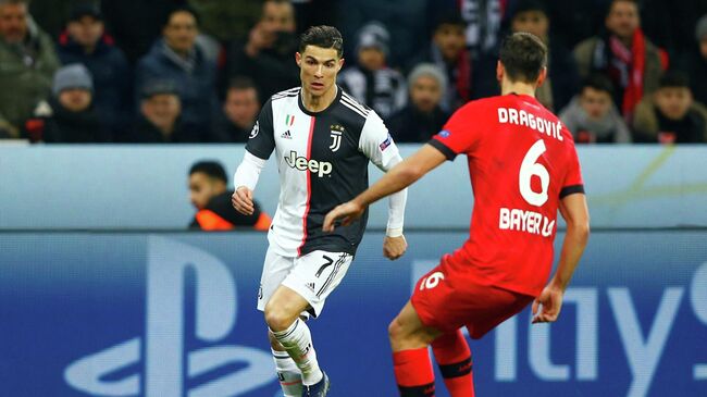 Soccer Football - Champions League - Group D - Bayer Leverkusen v Juventus - BayArena, Leverkusen, Germany - December 11, 2019  Juventus' Cristiano Ronaldo in action with Bayer Leverkusen's Aleksandar Dragovic   REUTERS/Thilo Schmuelgen