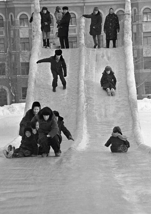 Дети катаются на ледяной горке в городе Пермь