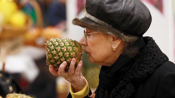 Женщина выбирает ананас 