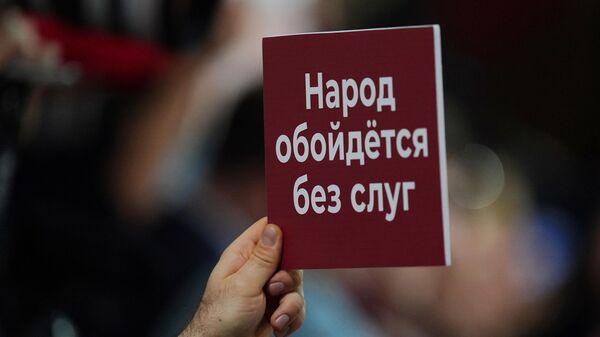 Плакат в руке журналиста, участвующего в большой ежегодной пресс-конференции президента РФ Владимира Путина 