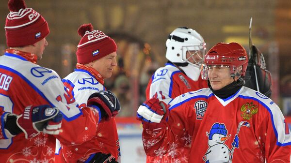 Президент РФ Владимир Путин приветствует игроков перед началом предновогоднего товарищеского матча Ночной хоккейной лиги на катке на Красной площади
