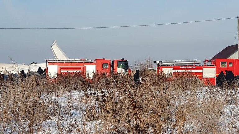 Сотрудники спасательной службы и полиции работают на месте крушения самолета Fokker 100 казахстанской авиакомпании Bek Air