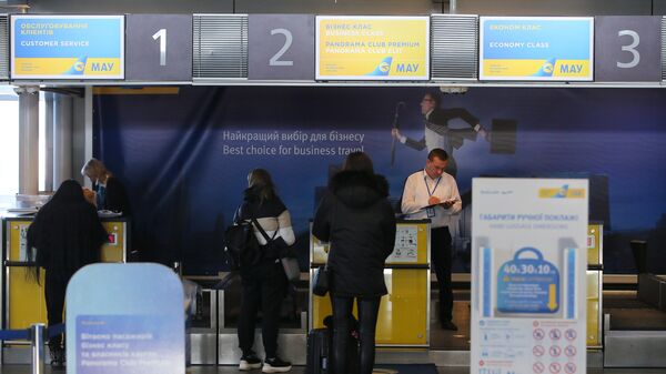Пассажиры у стойки регистрации авиакомпании Международные авиалинии Украины в аэропорту Борисполь в Киеве