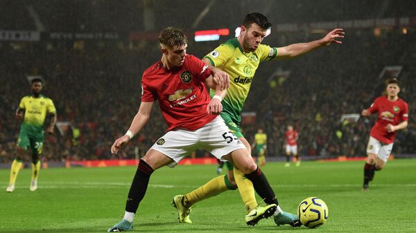 Norwich City's Scottish defender Grant Hanley (R) challenges Manchester United's English defender Brandon Williams (L) during the English Premier League football match between Manchester United and Norwich City at Old Trafford in Manchester, north west England, on January 11, 2020. (Photo by Oli SCARFF / AFP) / RESTRICTED TO EDITORIAL USE. No use with unauthorized audio, video, data, fixture lists, club/league logos or 'live' services. Online in-match use limited to 120 images. An additional 40 images may be used in extra time. No video emulation. Social media in-match use limited to 120 images. An additional 40 images may be used in extra time. No use in betting publications, games or single club/league/player publications. / 