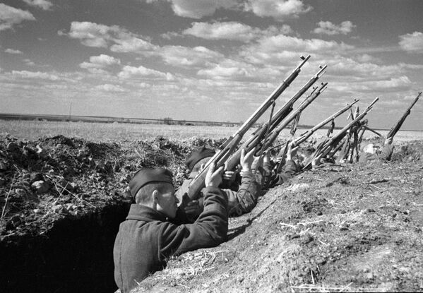 Советские воины ведут огонь из винтовок по вражескому самолету. Курская дуга