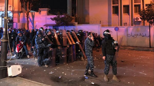 Сотрудники полиции во время столкновений с участниками антиправительственных демонстраций перед управлением МВД напротив посольства России в Бейруте