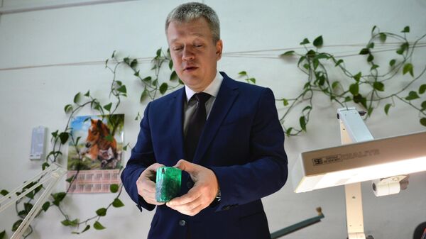 Генеральный директор АО Мариинский прииск Евгений Василевский демонстрирует редкий изумруд весом около 0,5 килограмма и стоимостью 55 тысяч долларов