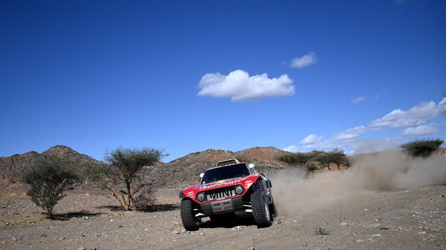 Bahrain JCW X-Raid team Spanish drivers Carlos Sainz of Spain and co-driver Lucas Cruz of Spain compete during the Stage 1 of the Dakar 2020 between Jeddah and Al Wajh, Saudi Arabia, on January 5, 2020. (Photo by FRANCK FIFE / AFP)