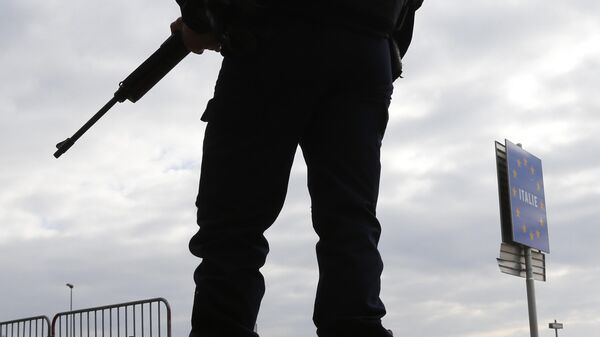An armed French policeman stands guard at the Franco-Italian border in Menton as part of security measures set following Paris' attacks on November 17, 2015 in Menton, south eastern France. Gunmen and suicide bombers went on a killing spree in Paris on Friday night, attacking a concert hall, bars, restaurants and the Stade de France. Islamic State jihadists operating out of Iraq and Syria released a statement claiming responsibility for the coordinated attacks that killed 129 people and left 352 others injured. AFP PHOTO / VALERY HACHE (Photo by VALERY HACHE / AFP)
