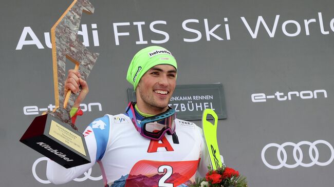 Alpine Skiing - FIS Ski World Cup - Men's Slalom - Kitzbuehel, Austria - January 26, 2020   Switzerland's Daniel Yule celebrates on the podium with a trophy after winning the Men's Slalom    REUTERS/Lisi Niesner