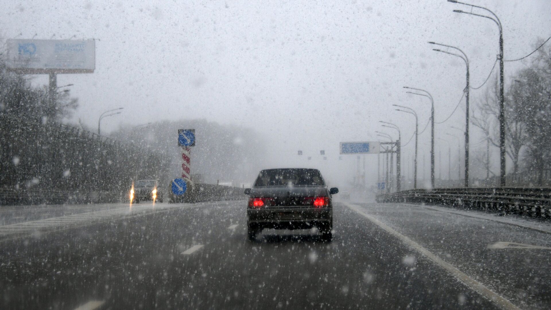 Автомобиль едет по Минскому шоссе во время снегопада в Москве - РИА Новости, 1920, 14.11.2021