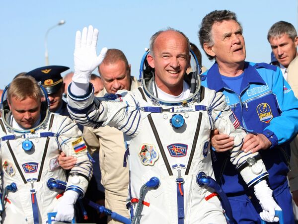 Максим Сураев (Роскосмос) и Джеффри Уильямс (НАСА) (слева направо) перед посадкой на борт космического корабля Союз ТМА-16 для полета к МКС