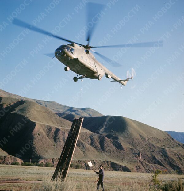 Вертолет МИ-8 перевозит связки опор для строящейся ЛЭП