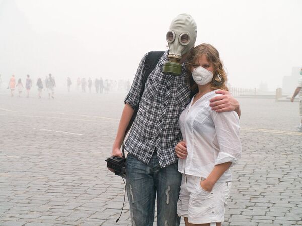Люди в защитных масках в период смога в Москве. Архив