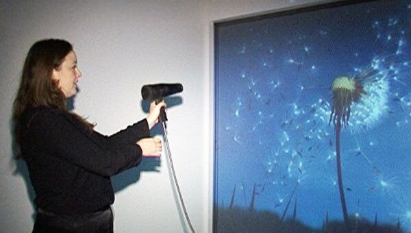 С цифрового одуванчика сдувают пушинки феном на выставке Decode 