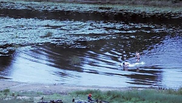 Вологжане переправляются через реку Вологду на велосипедах