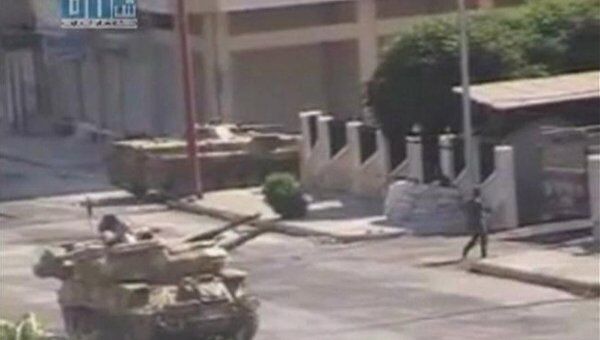 Видеокадр записи вооруженной обстановке в сирийском городе Хама