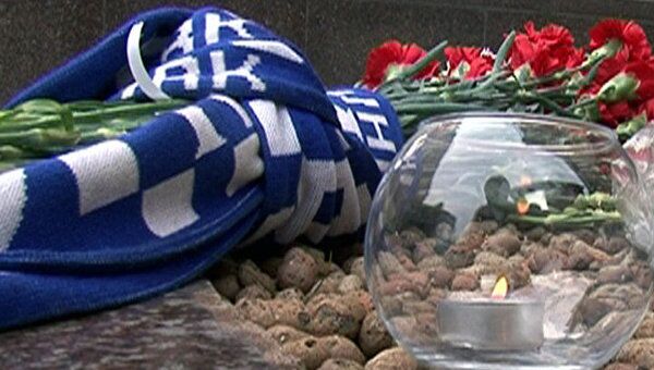 Свечи, цветы и шарфы в память о погибших хоккеистах у посольства Чехии