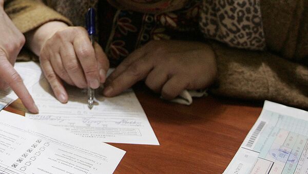 Женщина подписывает документы. Архивное фото