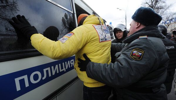 Сотрудники правоохранительных органов задерживают участника акции оппозиции на Пушкинской площади