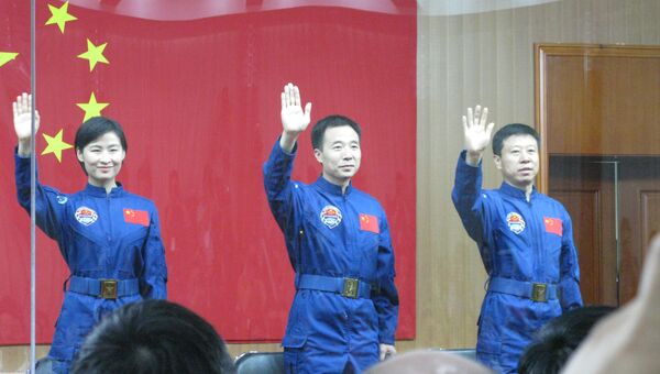 Встреча экипажа китайского космического корабля Шэньчжоу-9 с журналистами. Слева направо: Лю Ян, Цзин Хайпэн (командир), Лю Ван