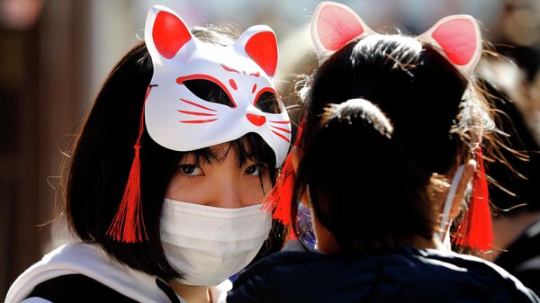 Девушки в защитных масках в Токио