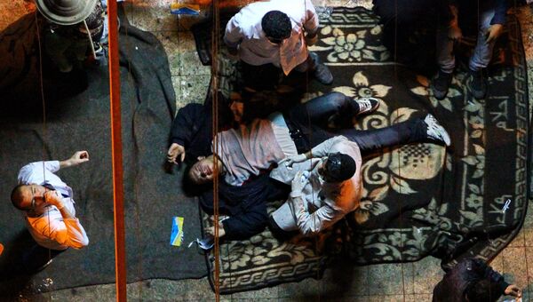 Раненые в ходе столкновений демонстрантов с полицией на каирской площади Тахрир, 23 ноября 2011.