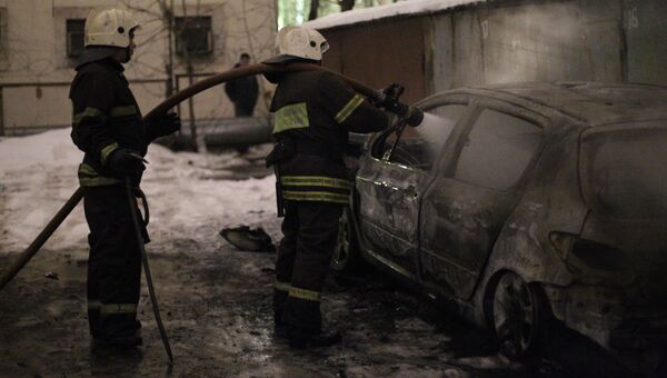 Пожарные тушат сгоревший автомобиль